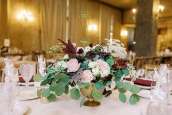 Elegant floral centerpiece on a banquet table set for a formal event.