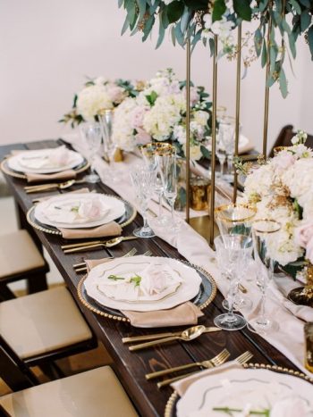 Elegant table setting with floral centerpieces for a formal event.