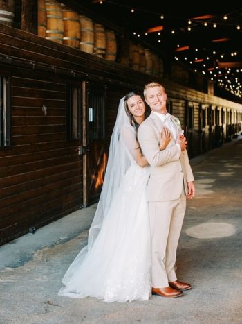 A joyful bride and groom embracing on their wedding day.