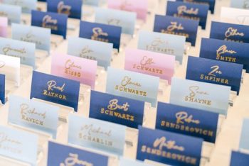 Rows of calligraphed place cards on a table.