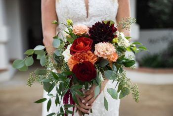 Bride holding a bouquet of flowers with a focus on the colorful arrangement.