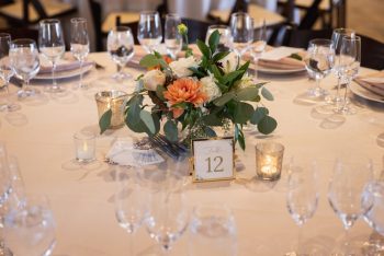 Elegant table setting for a formal event with floral centerpiece and table number twelve.