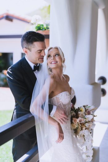 A bride and groom share an intimate moment on their wedding day.