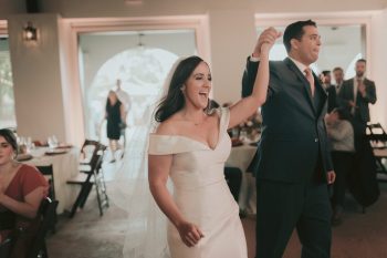 Bride and groom joyfully dancing at their wedding reception.